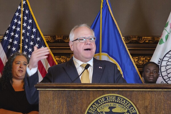 Democratic Minnesota Gov. Tim Walz speaks at a news conference at the Minnesota State Capitol in St. Paul on Wednesday, Aug. 16, 2023. Income tax rebates of $260 for individuals and up to $1,300 for families of five are already starting to show up in the bank accounts of about 2.1 million Minnesota residents. (AP Photo/Steve Karnowski)