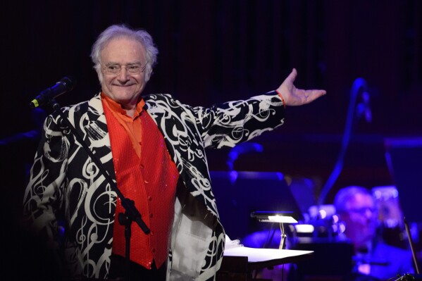 American-born conductor and composer Carl Davis thanks spectators during the Hollywood Night, the last concert of Prague Proms music festival in Prague, Czech Republic, on July 19, 2015. Carl Davis, the American composer and conductor behind the scores for numerous award-winning British television shows and movies, including 1973’s ‘The World at War,’ a hugely influential documentary series about World War II, has died. He was 86. (Michal Kamaryt/CTK via AP)