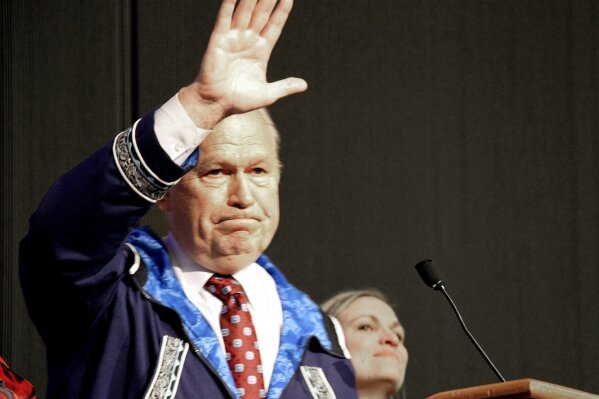 
              Alaska Gov. Bill Walker waves as he announces he will drop his re-election bid while addressing the Alaska Federation of Natives conference Friday, Oct. 19, 2018, in Anchorage, Alaska. Walker's re-election plans were dealt a blow earlier in the week after his running mate, Lt. Gov. Byron Mallott, resigned after making an inappropriate overture toward a woman. (AP Photo/Mark Thiessen)
            
