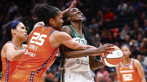 Seattle Storm's Ezi Magbegor is fouled by Connecticut Sun's Alyssa Thomas (25) during the first half of a WNBA basketball game Tuesday, June 20, 2023, in Seattle.  (Dean Rutz/The Seattle Times via AP)