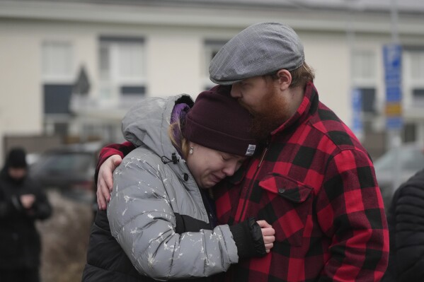 People gather at a memorial near the scene of the shooting in the outskirts of Orebro, Sweden on Wednesday, February 5th, 2025 (AP Photo/Sergei Grits)