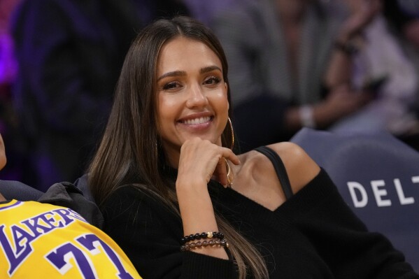 Actress Jessica Alba smiles during the second half of an NBA basketball game between the Los Angeles Lakers and the Houston Rockets, Friday, April 11, 2025, in Los Angeles. (AP Photo/Mark J. Terrill)