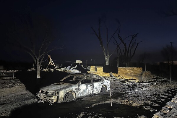 A charred vehicle sits near the ruins of a home after the property was burned by the Smokehouse Creek Fire, Wednesday, Feb. 28, 2024, in Fritch, Texas. (AP Photo/Ty O'Neil)