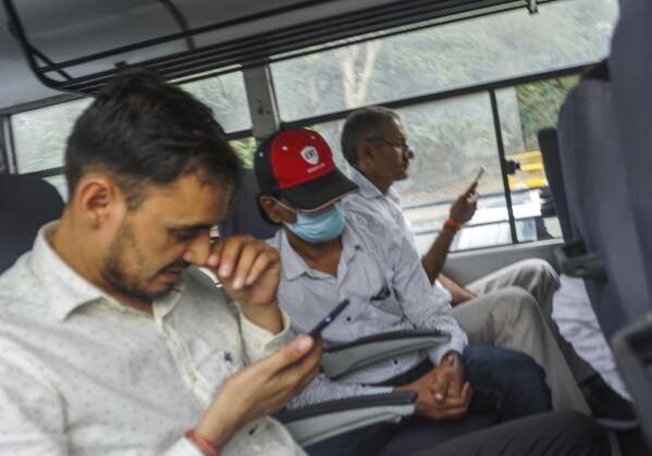 Indian journalist Mohammed Zubair, center, wearing cap, sits in a police vehicle after being produced in a court in New Delhi, India, Tuesday, June 28, 2022. Zubair, one of the co-founders of fact-checking website Alt News, was arrested by police Monday over a tweet that police said deliberately insulted "the god of a particular religion. (AP Photo)
