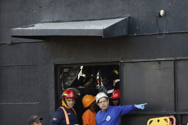 Rescue workers search for survivors at the Jet Set nightclub after its roof collapsed during a merengue concert in Santo Domingo, Dominican Republic, Tuesday, April 8, 2025. (AP Photo/Eddy Vittini)
