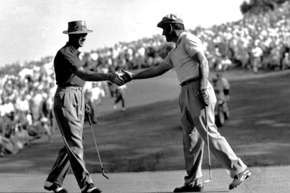 FILE - Johnny Palmer, right, congratulates Sam Snead, who won the national PGA Championship, on the 34th hole at Hermitage Country Club in Richmond, Va., May 31, 1949. Snead was the first player to win the Masters and the PGA in the same year. ( (Ǻ Photo, File)