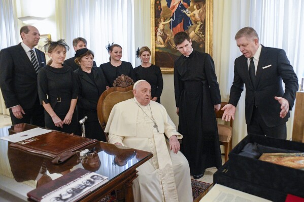 CORRECTS ID Pope Francis meets with Slovakia's Prime Minister Robert Fico, right, and his entourage at The Vatican Friday, Feb. 14, 2025. (Vatican Media via AP)