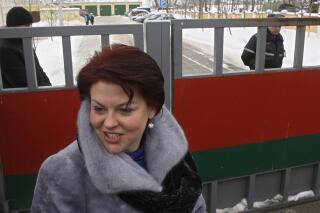 FILE - The leader of a banned ethnic Polish group Andzelika Borys, center, is seen in front of a court building in the town of Volozhin, 75 km ( 45 miles) northwest of Minsk, on Feb. 17, 2010. The prominent Polish minority activist has been released from custody in Belarus after the authorities dropped criminal charges against her. The Belarusian Prosecutor General’s office announced Tuesday, April 4, 2023 that the criminal investigation against Andzelika Borys has been terminated, all charges against her have been dropped and she has been freed from house arrest (AP Photo/Sergei Grits)