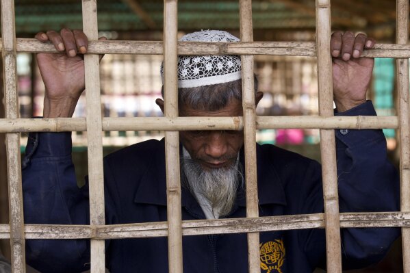 In this Wednesday, Jan. 17, 2018, photo, a Rohingya refugee reacts after seeing the long lines for aid material at Kutupalong refugee camp outside Cox's Bazar, Bangladesh. (AP Photo/Manish Swarup, File)