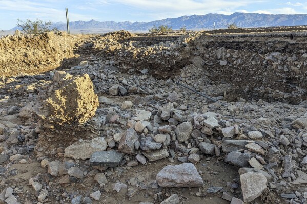 This undated photo released by the National Park Service shows California State Route 190 (SR 190) missing shoulders and undercut in several areas in Death Valley National Park, Calif., after Tropical Storm Hilary dropped more than 2 inches of rain on the park in August. On Monday, Sept. 4, 2023, officials say it could take months for the park to reopen to visitors after the storm. (Nico Ramirez/National Park Service via AP)