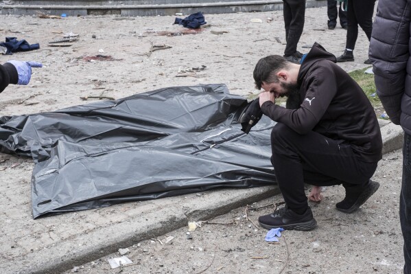 A man cries near dead bodies after a Russian missile strike on Sumy, Ukraine, Sunday, April 13, 2025. (AP Photo/Volodymyr Hordiienko)