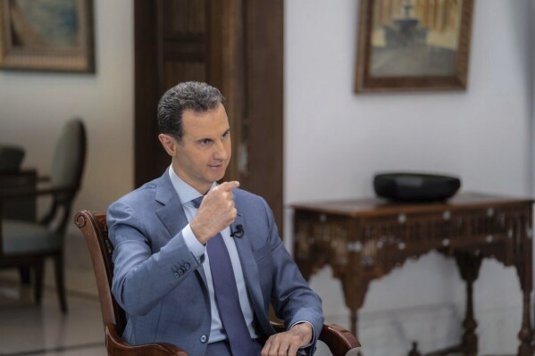 In this photo released on the official Telegram page of the Syrian Presidency, Syrian President Bashar Assad speaks during an interview in Damascus, Syria, Wednesday, Aug. 9, 2023. Assad blasted Turkey in comments published Wednesday blaming it for the spread of "terrorism" and trying to make its military presence in the war-torn country legitimate. (Syrian Presidency Telegram page via AP)