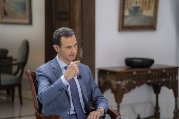 In this photo released on the official Telegram page of the Syrian Presidency, Syrian President Bashar Assad speaks during an interview in Damascus, Syria, Wednesday, Aug. 9, 2023. Assad blasted Turkey in comments published Wednesday blaming it for the spread of 