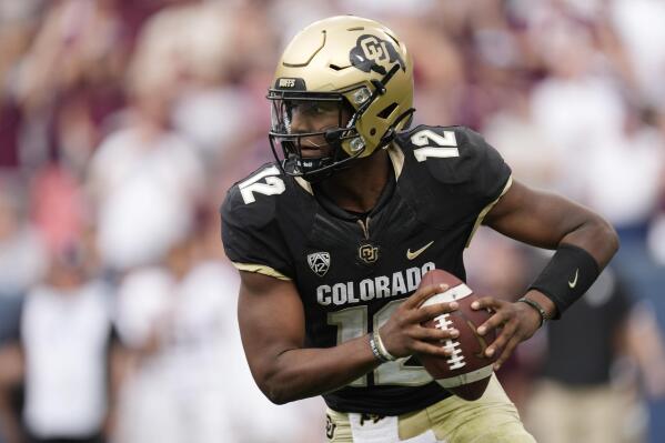 Colorado quarterback Brendon Lewis runs for a short gain in the second half of an NCAA college football game against Texas A&M, Saturday, Sept. 11, 2021, in Denver. Texas A&M won 10-7. (AP Photo/David Zalubowski)