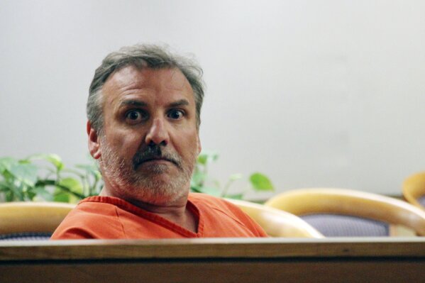 FILE - In this Wednesday, Oct. 16, 2019, file photo, Brian Steven Smith sits in a courtroom while waiting for his arraignment to start in Anchorage, Alaska. Losing a digital memory card that contained photos and videos of a horrendous killing may have been careless, but what led police to charge Smith was something he had no control over whatsoever: His South African accent. (AP Photo/Mark Thiessen, File)