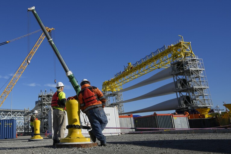 FILE - A generator and its blades are prepared to head to the ocean for the South Fork Wind farm from State Pier in New London, Conn., Dec. 4, 2023. By the end of 2023, the world will have added enough wind energy to power nearly 80 million homes, making it a record year. (AP Photo/Seth Wenig, File)