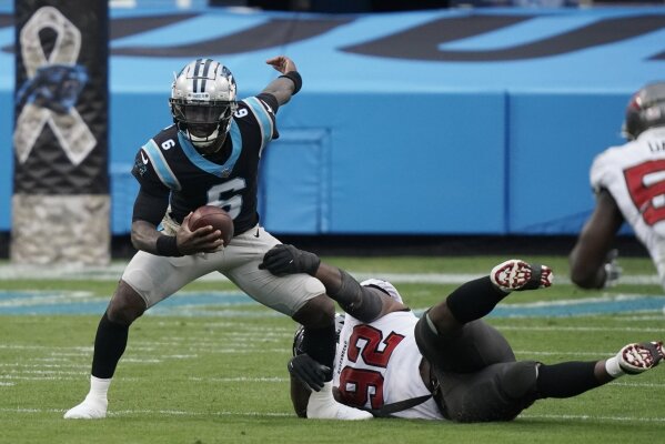 Carolina Panthers quarterback P.J. Walker (6) worlks as Tampa Bay Buccaneers defensive end William Gholston (92) defends during the second half of an NFL football game, Sunday, Nov. 15, 2020, in Charlotte , N.C. (AP Photo/Gerry Broome)