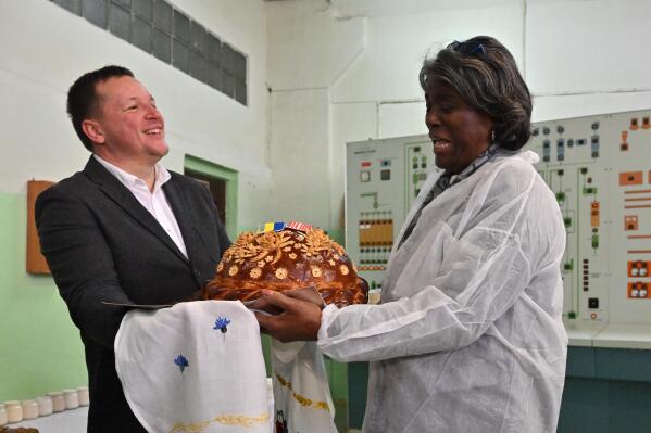 U.S. ambassador to the United Nations, Linda Thomas-Greenfield, right, is welcomed during her visit to the Kyiv Mlyn flour mill in Kyiv, Tuesday, Nov. 8, 2022. Thomas-Greenfield, reassured Ukrainian farmers Tuesday that it was a priority for the Secretary General to extend a wartime grain deal that allows Ukrainian grain and other commodities to be shipped to world markets. (Sergei Supinsky, Pool Photo via AP)