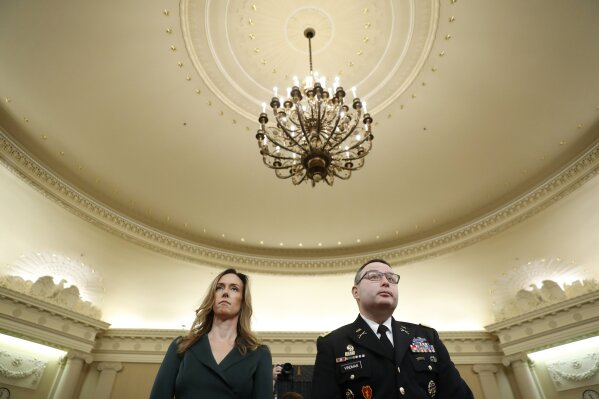 Jennifer Williams, an aide to Vice President Mike Pence, and National Security Council aide Lt. Col. Alexander Vindman stand as they take a break in hearing before the House Intelligence Committee on Capitol Hill in Washington, Tuesday, Nov. 19, 2019. (AP Photo/Andrew Harnik)