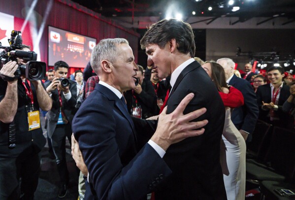 Mark Carney, Leader of the Liberal Party of Canada, embraces Prime Minister Justin Trudeau after being announced the winner at the Liberal leadership Event in Ottawa, Ontario, Sunday, March 9, 2025. (Justin Tang/The Canadian Press via AP)