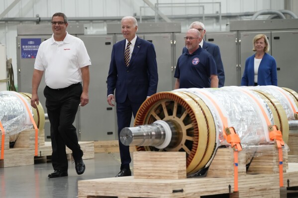 President Joe Biden and Mark Obradovich, Managing Director, Ingeteam, Inc., left, and others arrive at Ingeteteam Inc., in Milwaukee, Tuesday, Aug. 15, 2023. (AP Photo/Jacquelyn Martin)