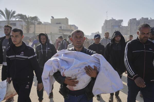 Mohammad Al-Qadi carrying body of his nephew who was killed in an Israeli army airstrike, during his funeral in Khan Younis, southern Gaza Strip, Saturday, April 19, 2025. (AP Photo/Abdel Kareem Hana)