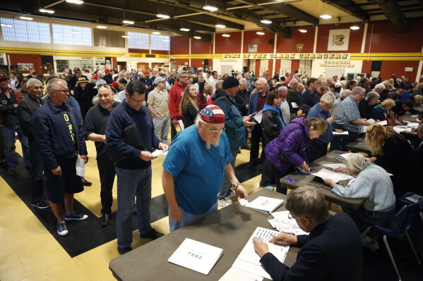 FILE - Crowds of people line up to get a ballot at a Republican caucus site, Feb. 23, 2016, in Las Vegas. (AP Photo/John Locher, File)