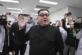A man impersonating North Korea's leader Kim Jong-un arrives as Prime Minister Scott Morrison leaves Extel Technologies manufacturing facility on Day 33 of the 2022 federal election campaign, in Melbourne, Australia, Friday, May 13, 2022. (Mick Tsikas/AAP Image via AP)