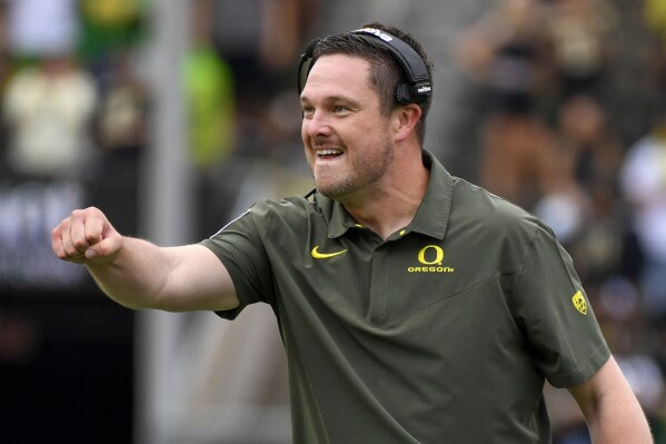 FILE - Oregon coach Dan Lanning reacts to a play against BYU during the first half of an NCAA college football game Sept. 17, 2022, in Eugene, Ore. Oregon and head coach Dan Lanning have agreed to a contract extension that will extend his deal through the 2028 season. The Oregon Board of Trustees unanimously approved the terms of the contract Thursday, July 27, 2023. Lanning’s new deal will pay him a total of $45 million in base salary over six years. (AP Photo/Andy Nelson, File)