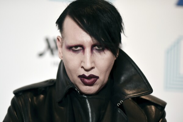 FILE - Marilyn Manson attends the 9th annual "Home for the Holidays" benefit concert in Los Angeles, on Dec. 10, 2019. An attorney in New Hampshire has filed a notice of intent to plead no contest on behalf of musical artist Marilyn Manson, who is accused of spitting and blowing his nose on a videographer at a 2019 concert. Manson, whose legal name is Brian Warner, is expected to plead no contest to just one of the misdemeanors on Thursday, July 20, 2023. (Photo by Richard Shotwell/Invision/AP, File)