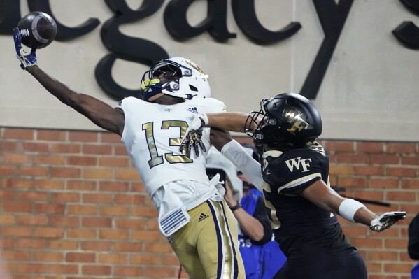Georgia Tech wide receiver Eric Singleton Jr. (13) reaches in vain for a pass as Wake Forest defensive back Nick Andersen (45) defends during the first half of an NCAA college football game in Winston-Salem, N.C., Saturday, Sept. 23, 2023. (AP Photo/Chuck Burton)