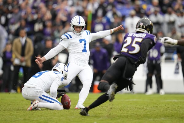 Indianapolis Colts place kicker Matt Gay (7) kicks the game winning field goal out of the hold of Rigoberto Sanchez during overtime of an NFL football game against the Baltimore Ravens, Sunday, Sept. 24, 2023, in Baltimore. (AP Photo/Julio Cortez)