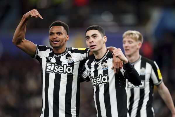 Newcastle United's Jacob Murphy, left, Miguel Almiron celebrate their third goal of the game during their English Premier League soccer match at Villa Park, Birmingham, England, Tuesday, Jan. 30, 2024. (Jacob King/PA via AP)