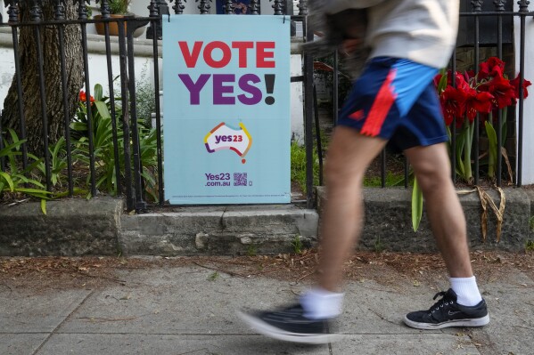 FILE - A pedestrian walks past a vote Yes poster for the Voice referendum in Sydney, Australia, Monday, Sept. 11, 2023. Australia’s Prime Minister Anthony Albanese said Tuesday, Sept. 26, that opinion polls suggest Indigenous Australians overwhelmingly support a proposal to create their own representative body to advise Parliament and have it enshrined in the constitution. (AP Photo/Mark Baker, File)