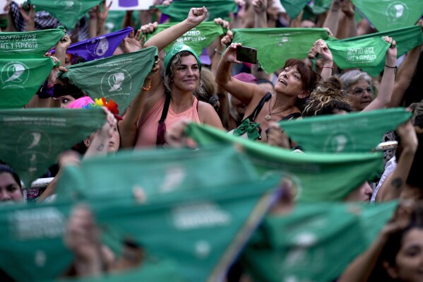 Women hold up green bandanas, a symbol of abortion rights in Latin America, during an International Women's Day march in Buenos Aires, Argentina, Friday, March 8, 2024. (AP Photo/Natacha Pisarenko)