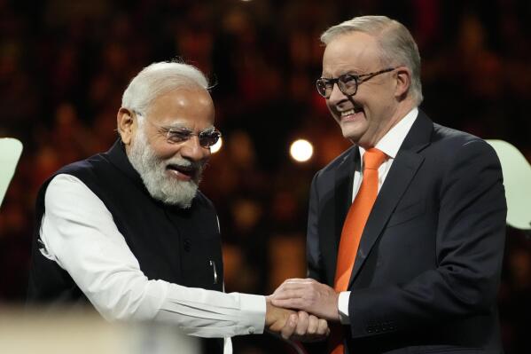 Indian Prime Minister Narendra Modi, left, shakes hands with Australian Prime Minister Anthony Albanese during an Indian community event at Qudos Bank Arena in Sydney, Australia, Tuesday, May 23, 2023. Modi has arrived in Sydney for his second Australian visit as India's prime minister and told local media he wants closer bilateral defense and security ties as China's influence in the Indo-Pacific region grows. (AP Photo/Mark Baker)