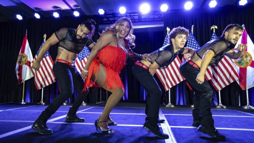 Drag performer Velvet LeNore joins dancers on stage during the gala at the Florida Democratic Party's Annual Leadership Blue Weekend at the Fontainebleau Hotel on Miami Beach, Fla., Saturday, July 8, 2023. (Al Diaz/Miami Herald via AP)