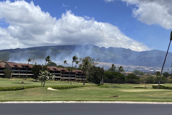 Smoke rises in the hills above the Kaanapali resort hotel area of Lahaina, Hawaii on Saturday, August 26, 2023. A brush fire on Saturday prompted Maui authorities to evacuate residents from a neighborhood of Lahaina, just a few miles from the site recently ravaged by blazes. (Cindy Ellen Russell/Honolulu Star-Advertiser via AP)
