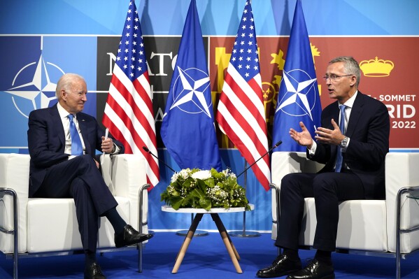 FILE - President Joe Biden, left, speaks with NATO Secretary General Jens Stoltenberg during a meeting at the NATO summit in Madrid, Spain on June 29, 2022. Biden is welcoming outgoing NATO Secretary-General Jens Stoltenberg to the White House on Monday, June 12, 2023, as the competition to find his successor to lead the military alliance heats up. Stoltenberg, who has led NATO since 2014 indicated earlier this year he would move on when his term expires at the end of September. (AP Photo/Susan Walsh, File)