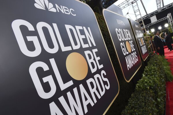 FILE - Event signage appears above the red carpet at the 77th annual Golden Globe Awards, Sunday, Jan. 5, 2020, in Beverly Hills, Calif. More than 100 Hollywood publicity firms that collectively re...