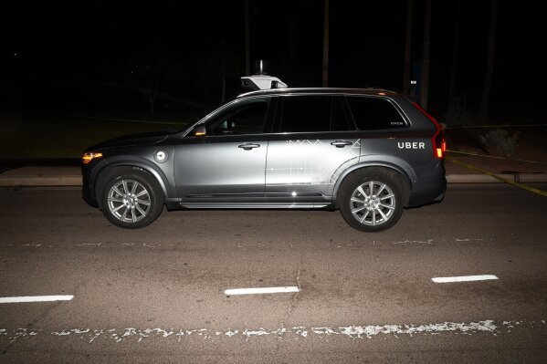 
              FILE - This file photo provided by the Tempe Police Department shows an Uber SUV after hitting a woman on March 18, 2018, in Tempe, Ariz.  Nearly eight months after one of its autonomous test vehicles hit and killed an Arizona pedestrian, Uber wants to resume testing on public roads. The company has filed an application with the Pennsylvania Department of Transportation to test in Pittsburgh, and it has issued a lengthy safety report pledging to put two human backup drivers in each vehicle and take a raft of other precautions to make the vehicles safe. Company officials acknowledge they have a long way to go to regain public trust after the March 18 crash in Tempe, Arizona, that killed Elaine Herzberg, as she crossed a darkened road outside the lines of a crosswalk. (Tempe Police Department via AP, File)
            