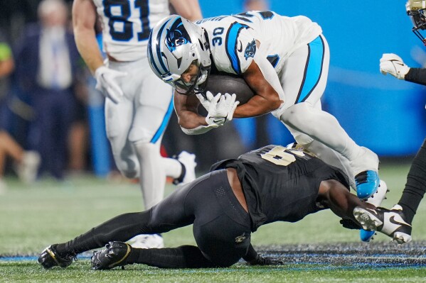 Carolina Panthers running back Chuba Hubbard is tackled by New Orleans Saints safety Marcus Maye during the second half of an NFL football game Monday, Sept. 18, 2023, in Charlotte, N.C. (AP Photo/Rusty Jones)
