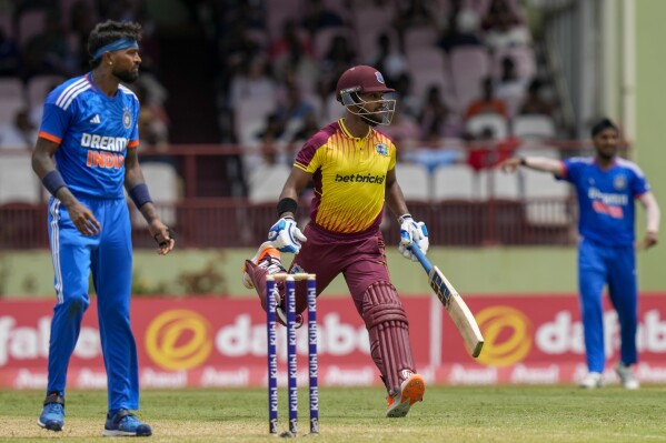 West Indies' Nicholas Pooran scores runs against India during their second T20 cricket match at Providence Stadium in Georgetown, Guyana, Sunday, Aug. 6, 2023. (AP Photo/Ramon Espinosa)