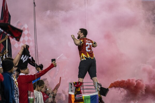 A New York Red Bulls fan celebrates after a goal against Toronto FC during an MLS soccer match Saturday, Oct. 7, 2023, in Harrison, N.J. (AP Photo/Eduardo Munoz Alvarez)