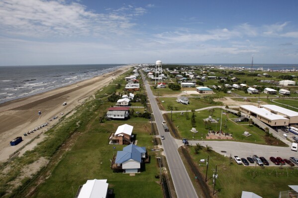 FILE - Louisiana State Highway 1 is seen from above Grand Isle, La., on July 27, 2010. Grand Isle will repeal an anti-obscenity ordinance and let a contractor fly a flag from his truck that carries an obscenity aimed at President Joe Biden, under the terms of a lawsuit settlement filed Friday, Sept. 15, 2023, in federal court. (AP Photo/Patrick Semansky, File)