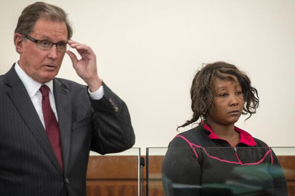 Lawyer Michael S. Hussey represents Yvonne Ngoiri during her arraignment in Worcester Superior Court, Friday, Sept. 30, 2022, in Worcester, Mass. Ngoiri , a former tenant charged with setting a fire at a Massachusetts apartment building that claimed the lives of four people pleaded not guilty at her arraignment Friday and was held without bail. (Rick Cinclair/Worcester Telegram & Gazette via AP)
