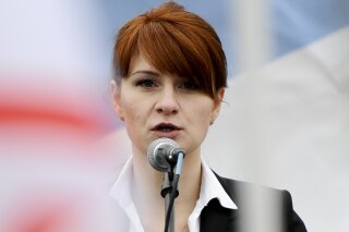 
              FILE - In this Sunday, April 21, 2013,  file photo, Maria Butina, leader of a pro-gun organization in Russia, speaks to a crowd during a rally in support of legalizing the possession of handguns in Moscow, Russia. A year before federal prosecutors accused Butina of being a secret agent for the Russian government, she was a graduate student at American University working on a sensitive project involving cybersecurity. Her university assignment called for her to gather information on the cyber defenses of U.S. non-profits that champion media freedom, human rights and similar causes. (AP Photo/File)
            