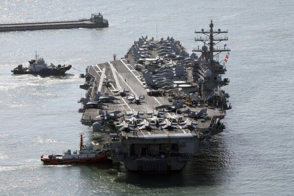 U.S. nuclear-powered aircraft carrier USS Ronald Reagan is escorted as it arrives in Busan, South Korea, Thursday, Oct. 12, 2023. (Kang Duck-chul/Yonhap via AP)