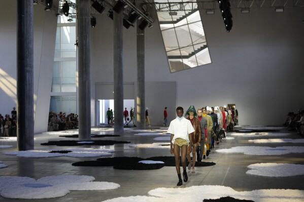 Models wear creations as part of the men's Prada Spring-Summer 2026 collection, that was presented in Milan, Italy, Sunday, June 22, 2025. (AP Photo/Luca Bruno)