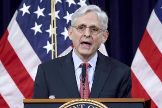 FILE - In this June 15, 2021, file photo, Attorney General Merrick Garland speaks at the Justice Department in Washington. In his first wide-ranging question-and-answer session with reporters, Garland talked about the death penalty, the department's defense of former President Donald Trump against a defamation suit and the protection of journalists and their sources.(Win McNamee/Pool via AP)
